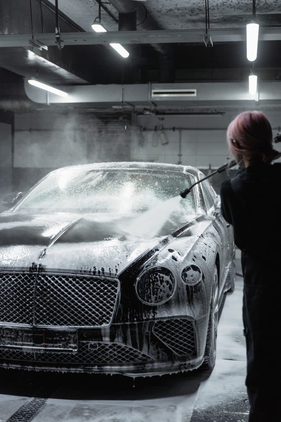 Luxury sedan covered in foam during a wash